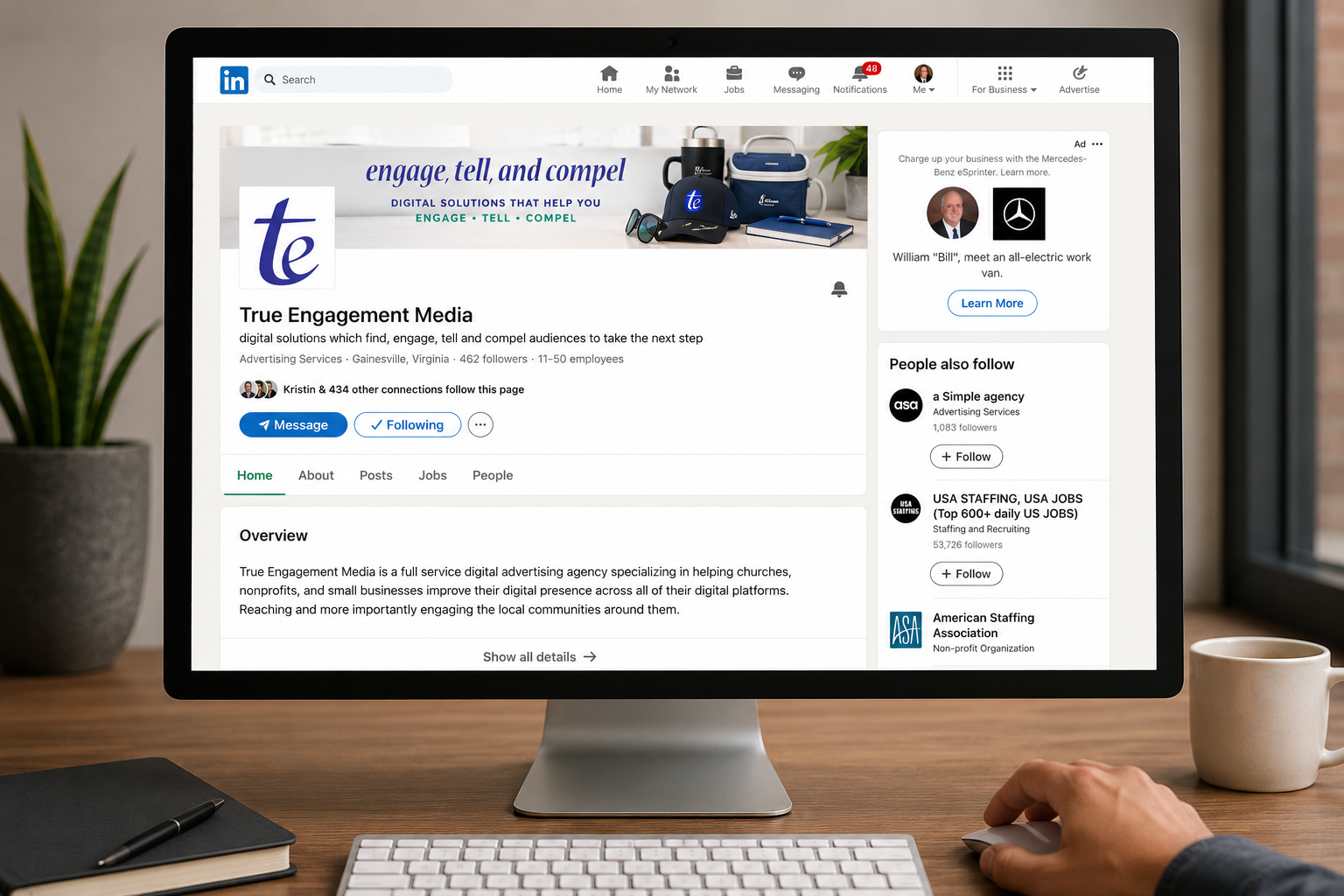 Person using a desktop computer showing the True Engagement LinkedIn company page
