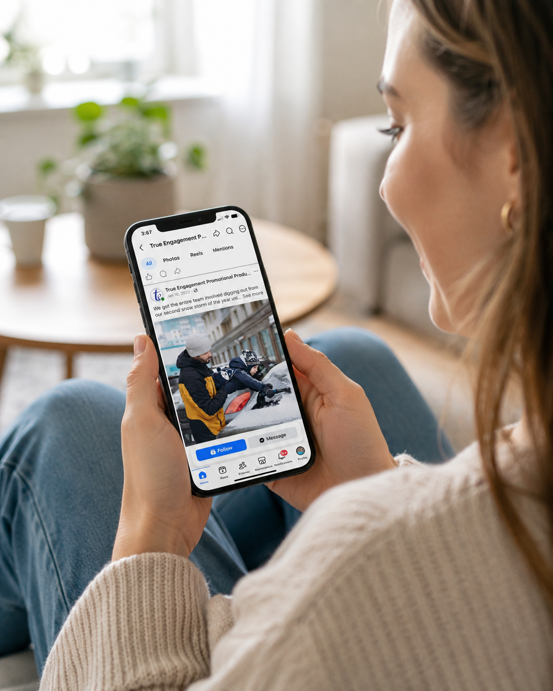Person viewing the True Engagement Facebook page on an iPhone